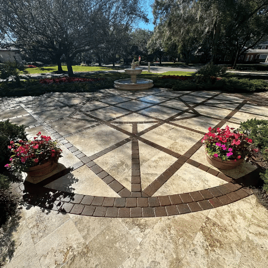 Elegant garden pathway with a central fountain surrounded by vibrant flower planters.